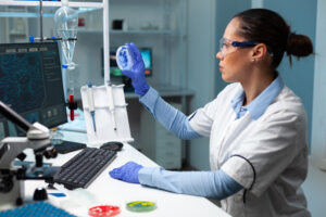 Female scientist examining a petri dish in a modern laboratory.