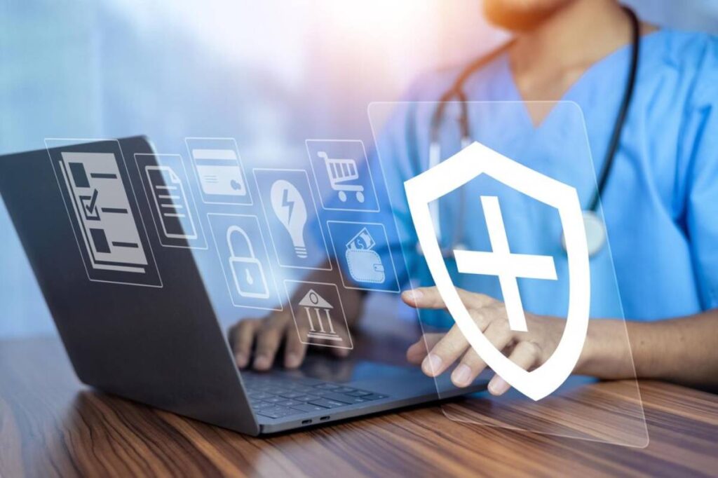 A healthcare professional in scrubs uses a laptop, with digital icons displaying medical, security