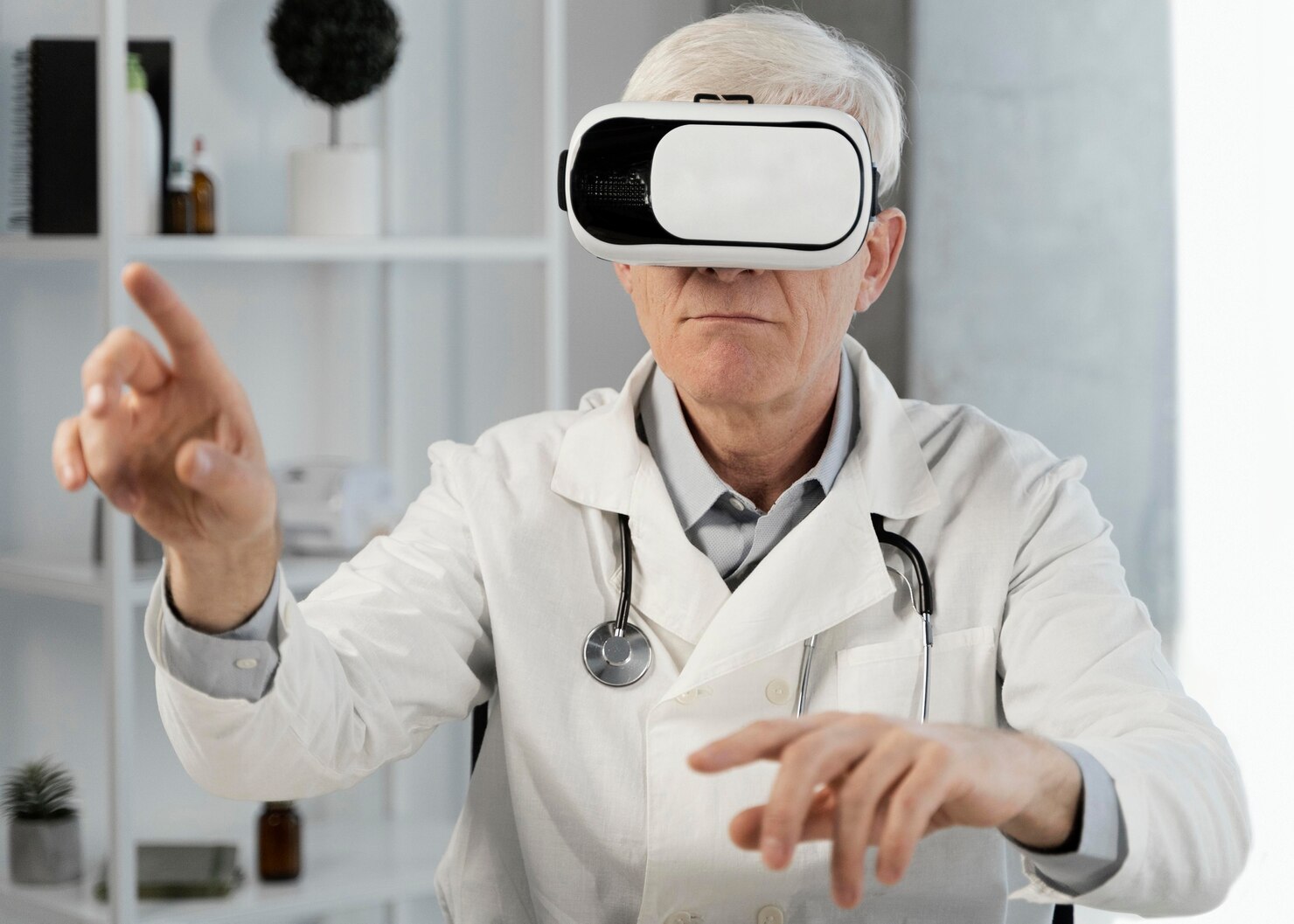 Senior male doctor wearing a VR headset, gesturing with hands in a modern office setting.