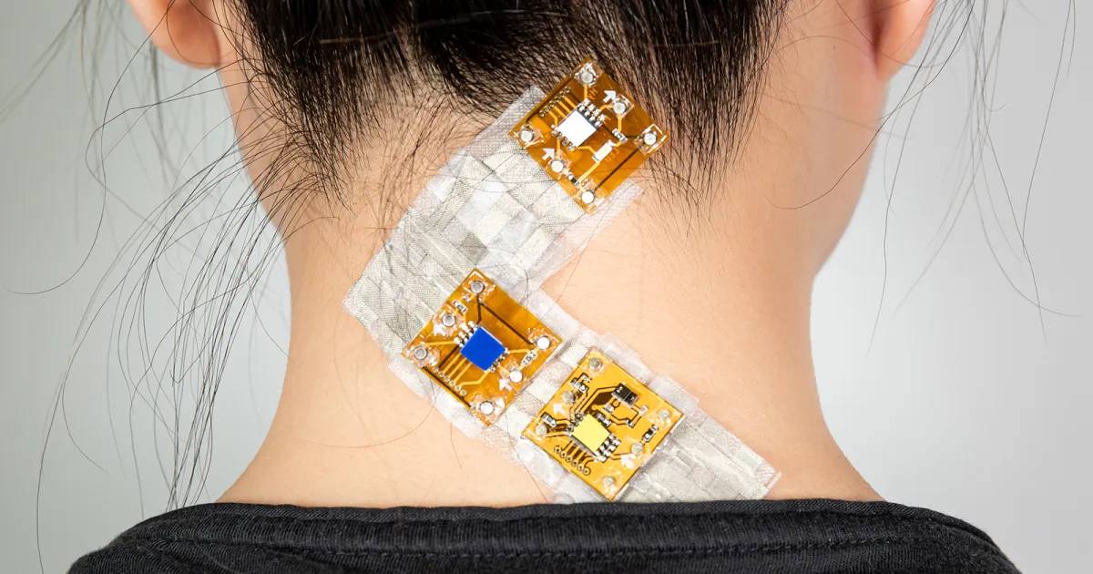 Woman with electronic patches attached to her neck, possibly for health monitoring or therapeutic purposes.
